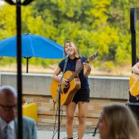 Two band members singing and playing guitar.